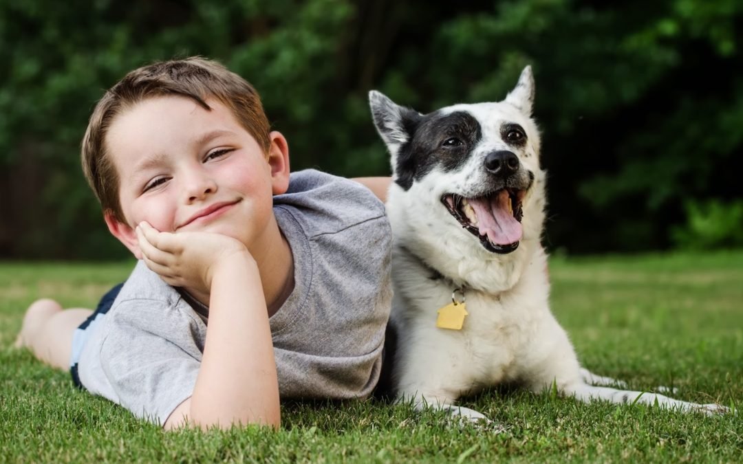 Young boy and dog enjoying clean yard following pooper scooper cleanup service